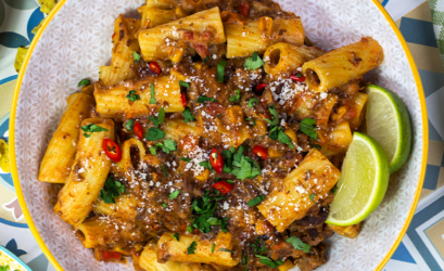 Bowl of Chipotle Beef Pasta made with Chilli Con Carne Gourmet Sause Mix on a table with colourful décor