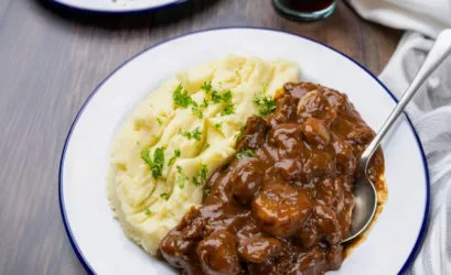Slow cooker Beef Bourguignon with tender beef, shallots and mushrooms served with creamy mashed potato