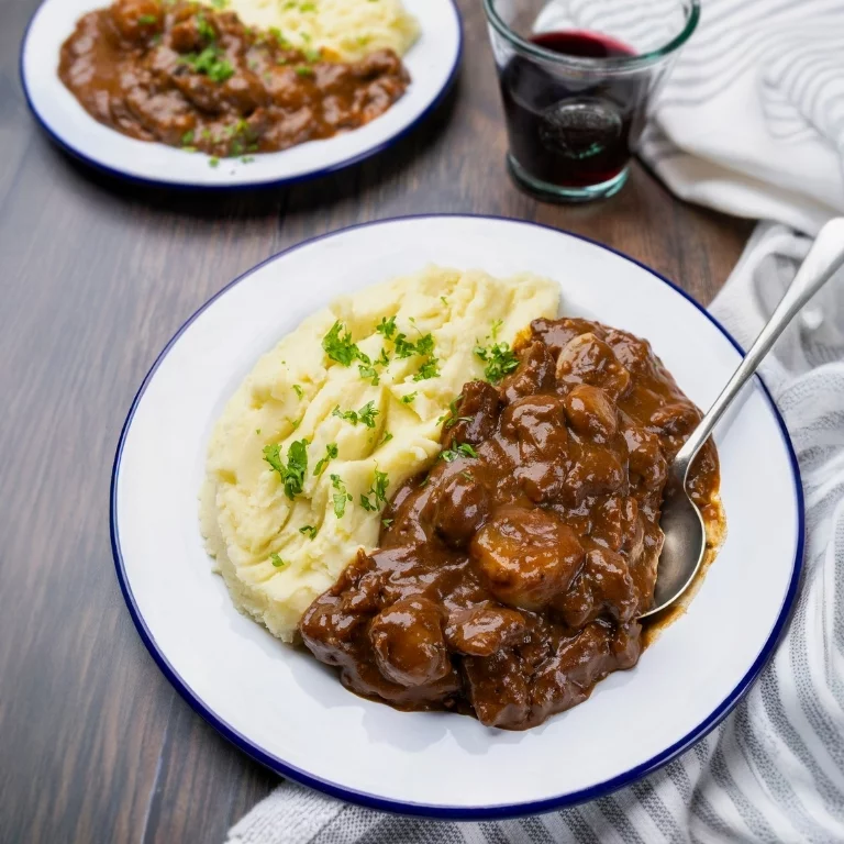 Slow cooker Beef Bourguignon with tender beef, shallots and mushrooms served with creamy mashed potato