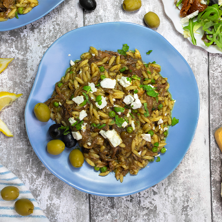 Plate of Greek Pulled Lamb Orzo made using Slow and Steamy Tagine Gourmet Sauce Mix with Feta cheese and Fresh mint to garnish